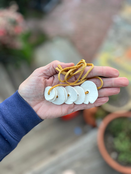 graduated disc jewelry on soft leather yellow cord samples/seconds/sale piece