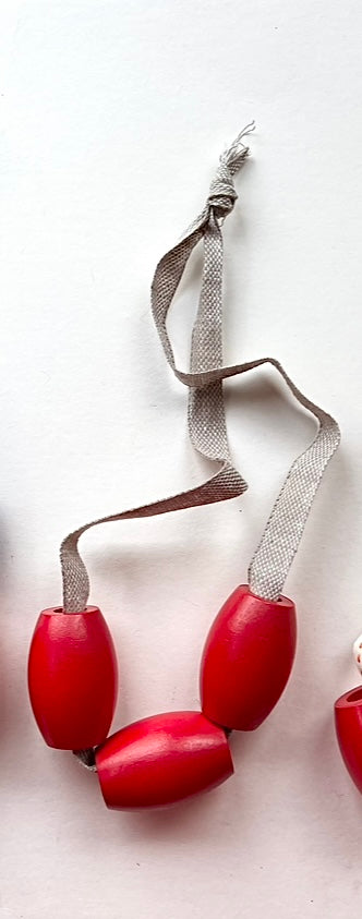 vintage red wooden bead jewelry on tan linen twill cording samples/seconds/sale piece