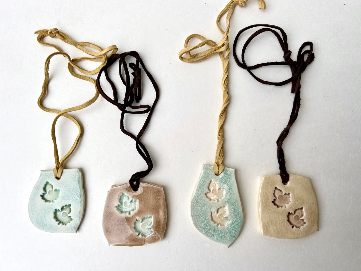 celadon & mocha cream crackle glazed leaf jewelry on soft brown leather samples/seconds/sale piece