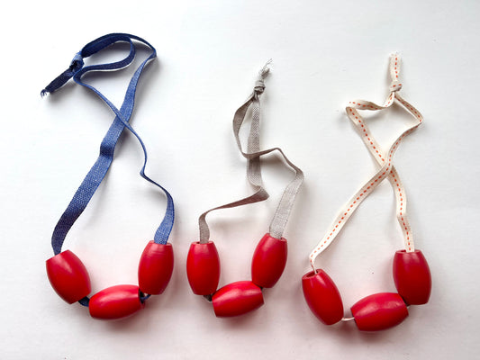vintage red wooden bead jewelry on tan linen twill cording samples/seconds/sale piece