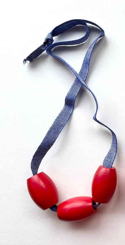 vintage red wooden bead jewelry on blue linen twill cording samples/seconds/sale piece