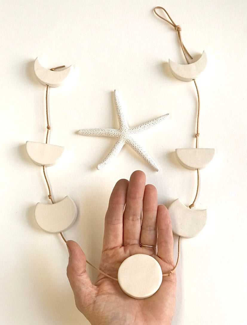 silvered sky & earth; matte white ceramic moon phases vertical wall hanging