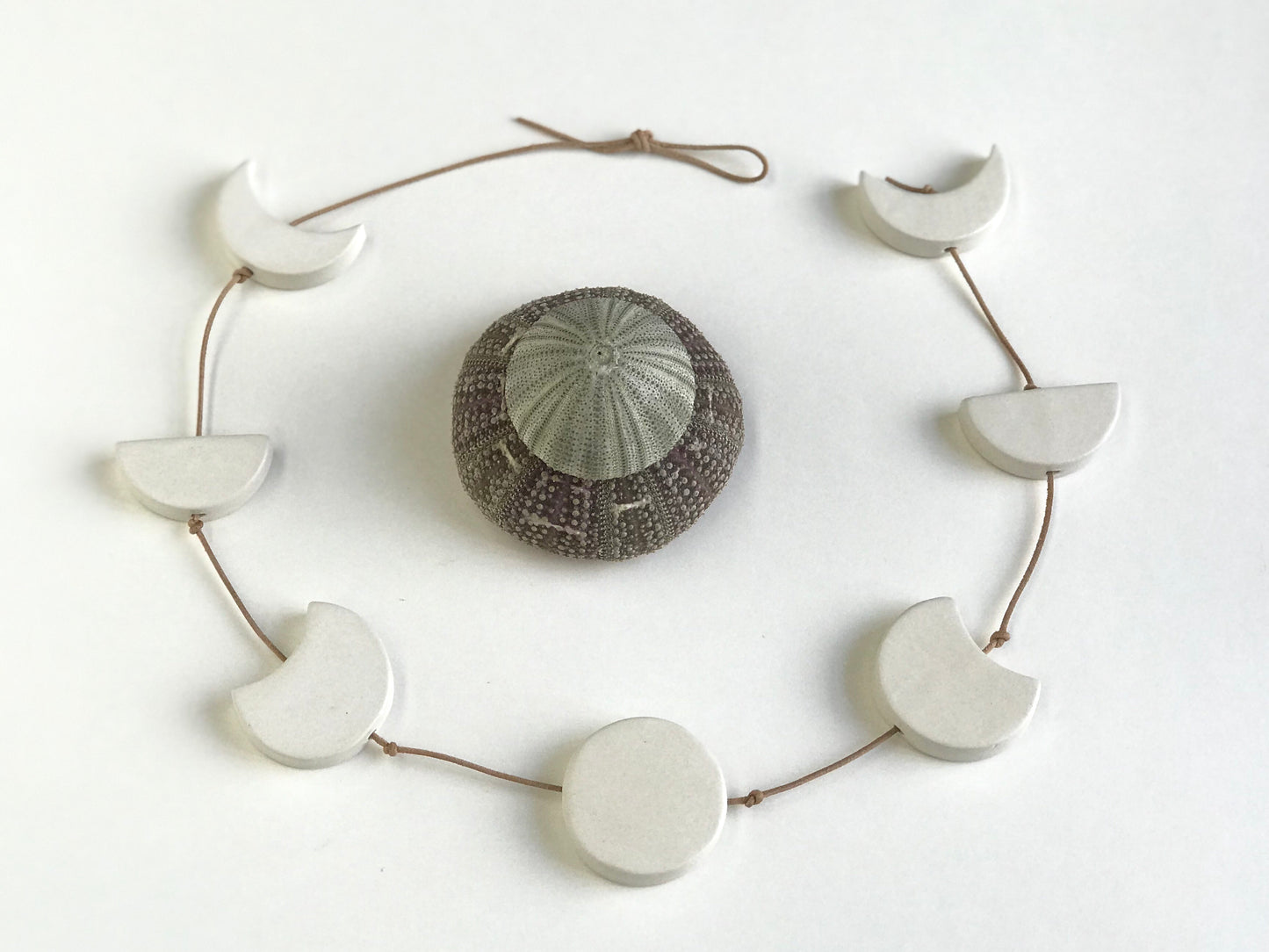 silvered sky & earth; matte white ceramic moon phases vertical wall hanging