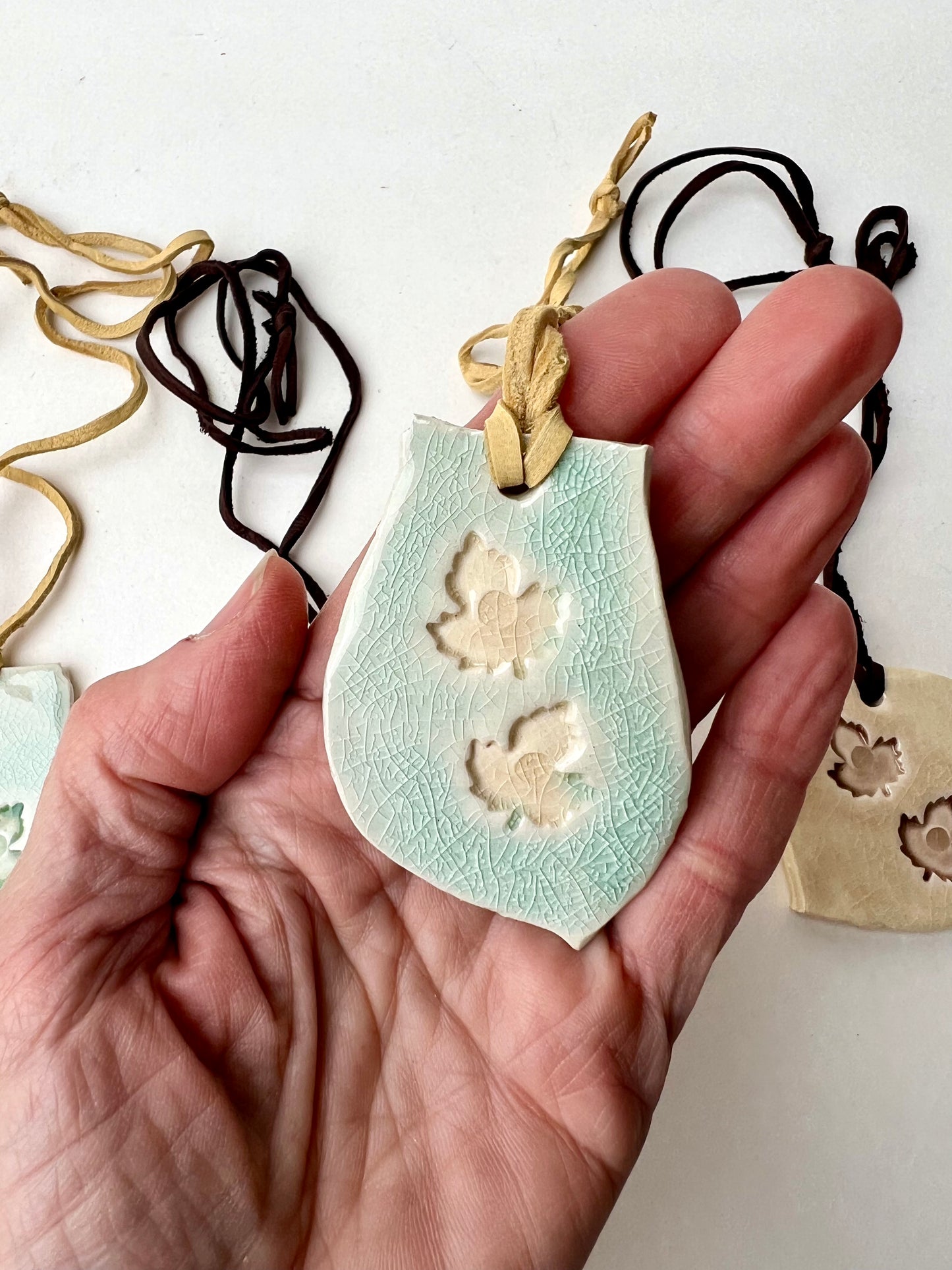 celadon crackle & parchment leaf jewelry on butter yellow leather samples/seconds/sale piece