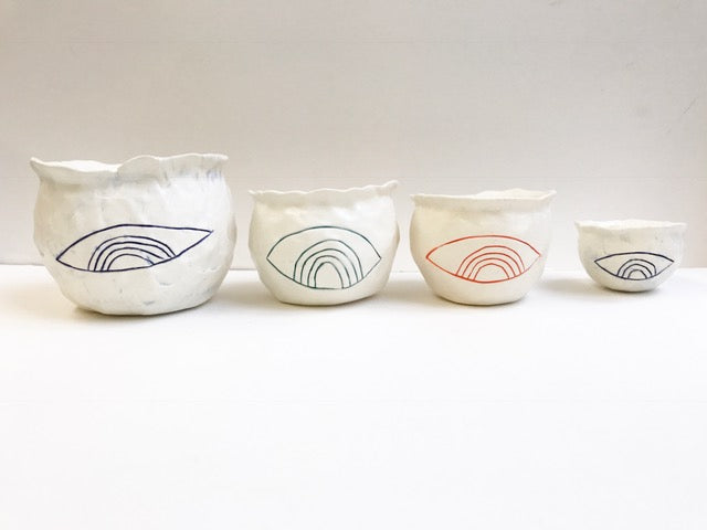 sold talisman containers; set of 4 rainbow/eye design