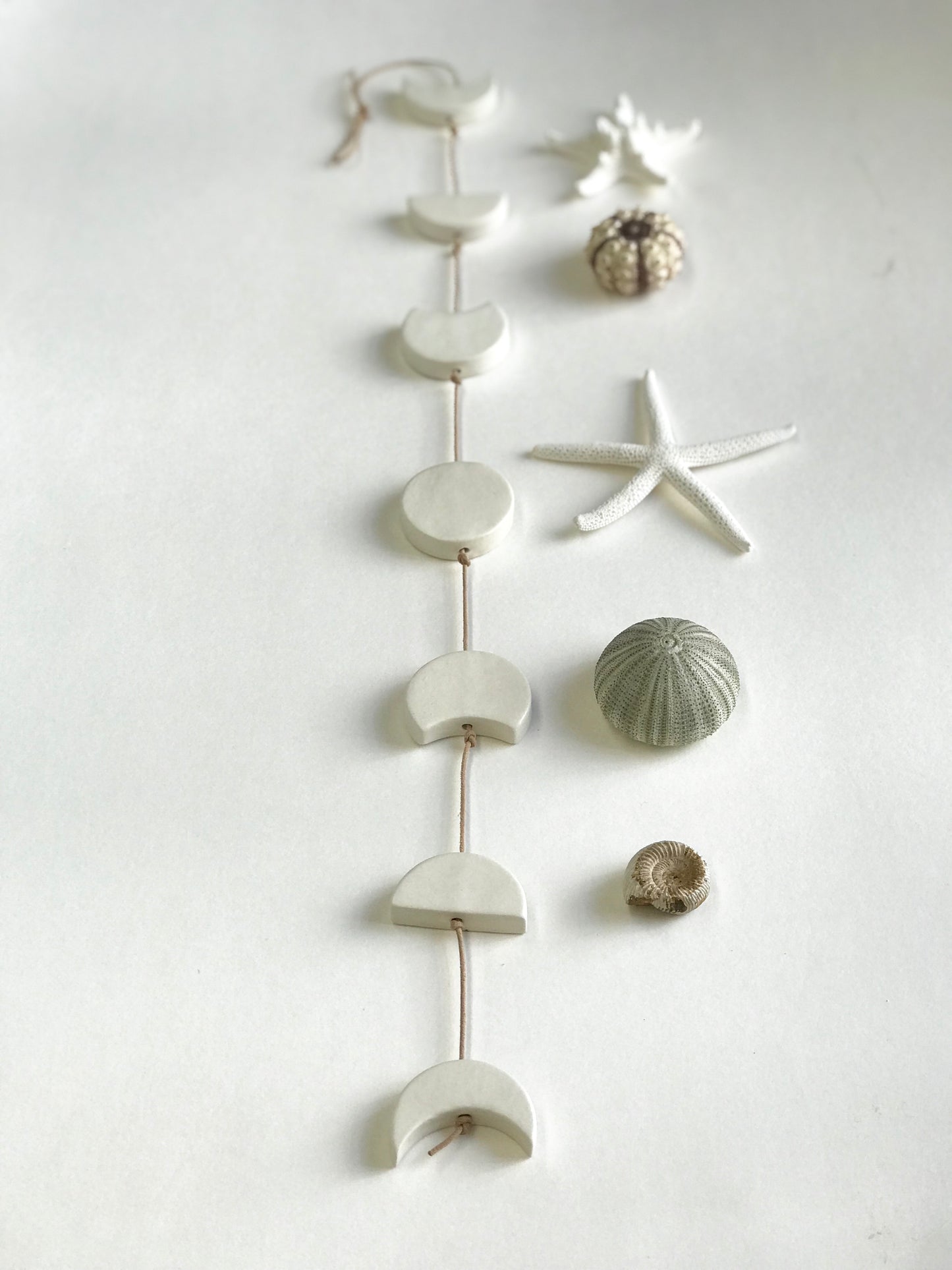 silvered sky & earth; matte white ceramic moon phases vertical wall hanging